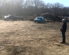 Lake City Public Works employee Sam Kittleson watches materials being unloaded at the Lake City compost site shortly after the site opened for the season.